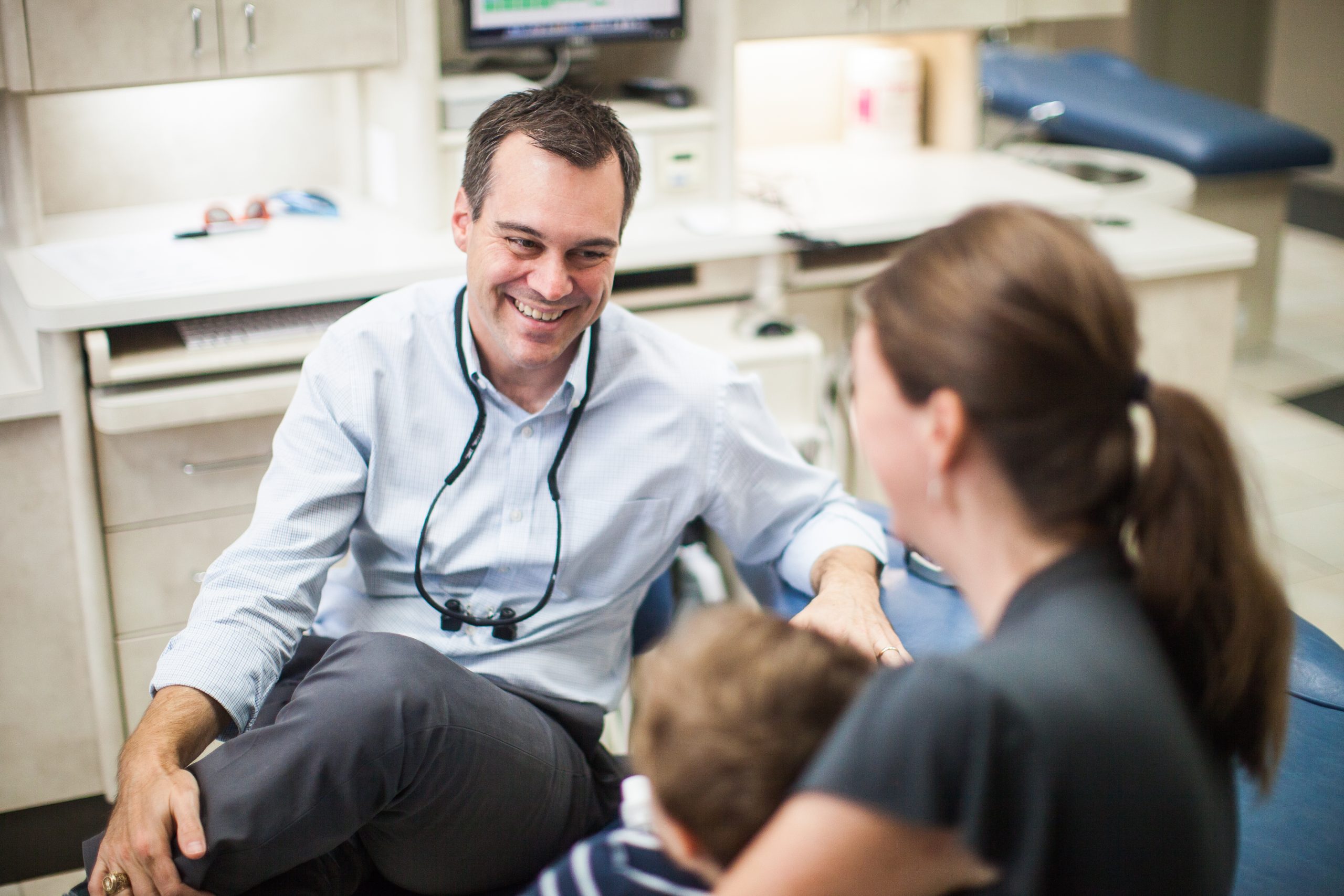 Young child being held during a friendly pediatric dental visit